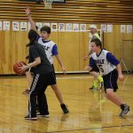 A Wolf Student works on blocking his parent as students play defense