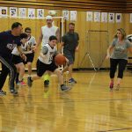 A Wolf student steals the ball and moves towards the basket