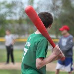 An 8th grader steps up to the plate at field day