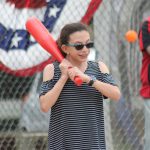 A Room 6 student takes her turn at bat